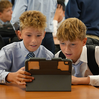 Two students on an iPad. Links to Gifts of Appreciated Securities Two students on an iPad. Links to Gifts of Appreciated Securities