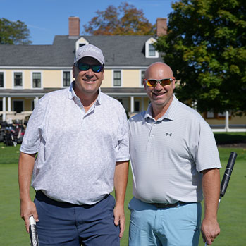 Two alumni outside holding golf clubs. Links to Beneficiary Designations Two alumni outside holding golf clubs. Links to Beneficiary Designations