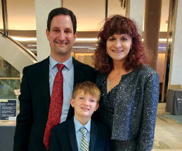 Karen and Jamie Heller ’93 P’30 with their son Benjamin. Links to their story